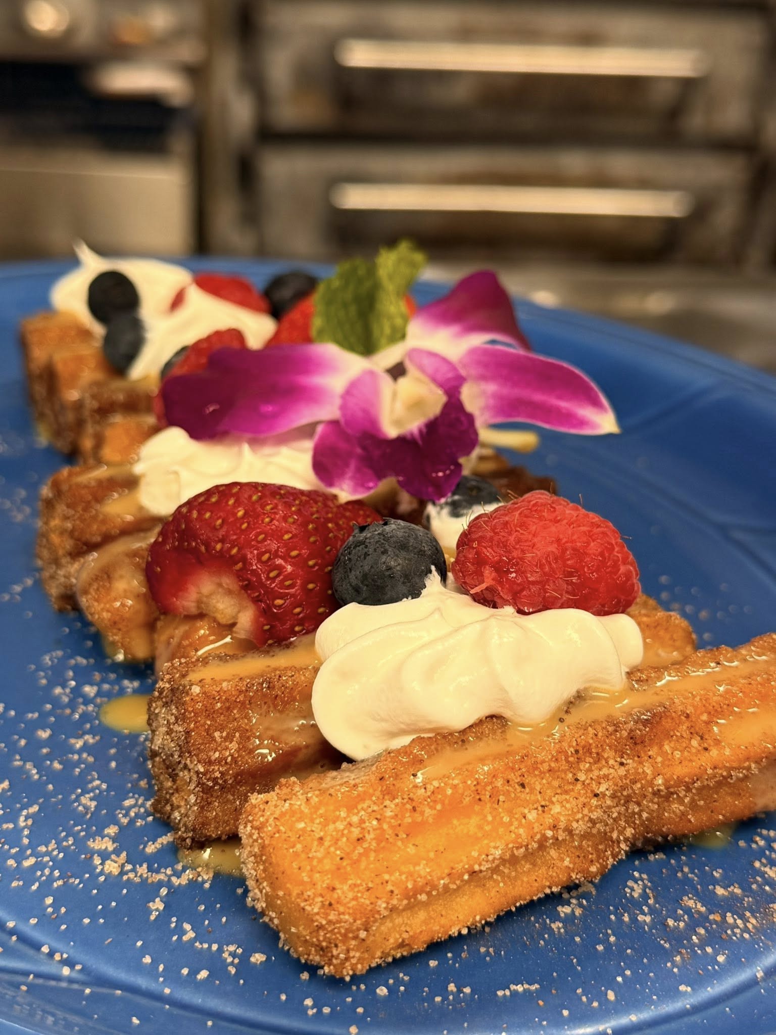 Cinnamon-sugar churros with strawberries and cream